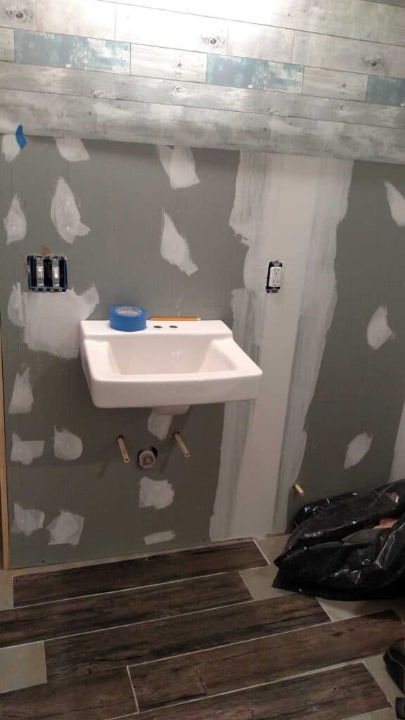 Downstairs Bathroom Part 3 http://www.b4andafters.com drywall with patching spots on sink bathroom wall