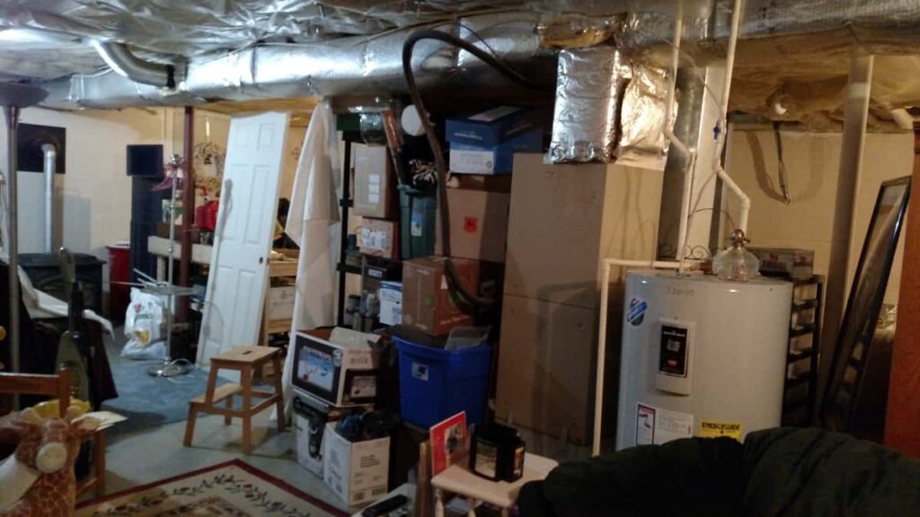 Organize With Curtains http://www.b4andafters.com mess of boxes and storage in basement
