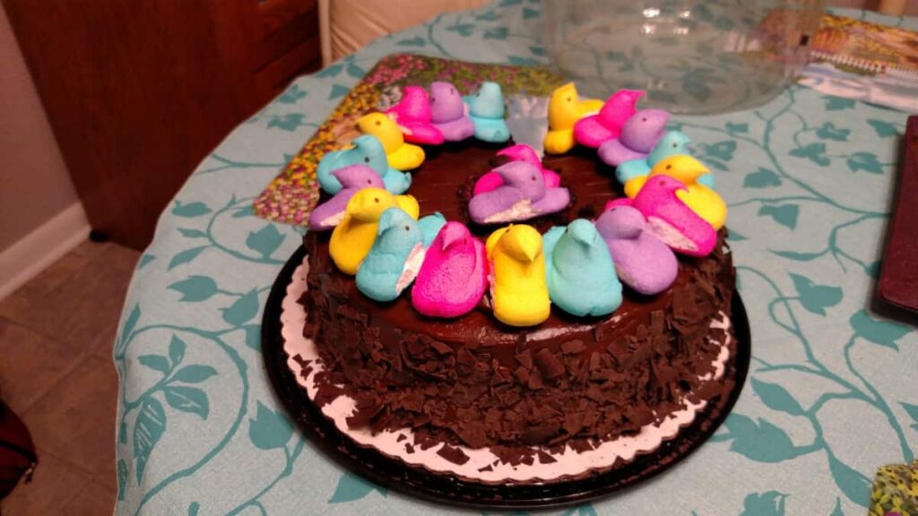 chocolate cake with various colors of marshmallow chicken peeps on it