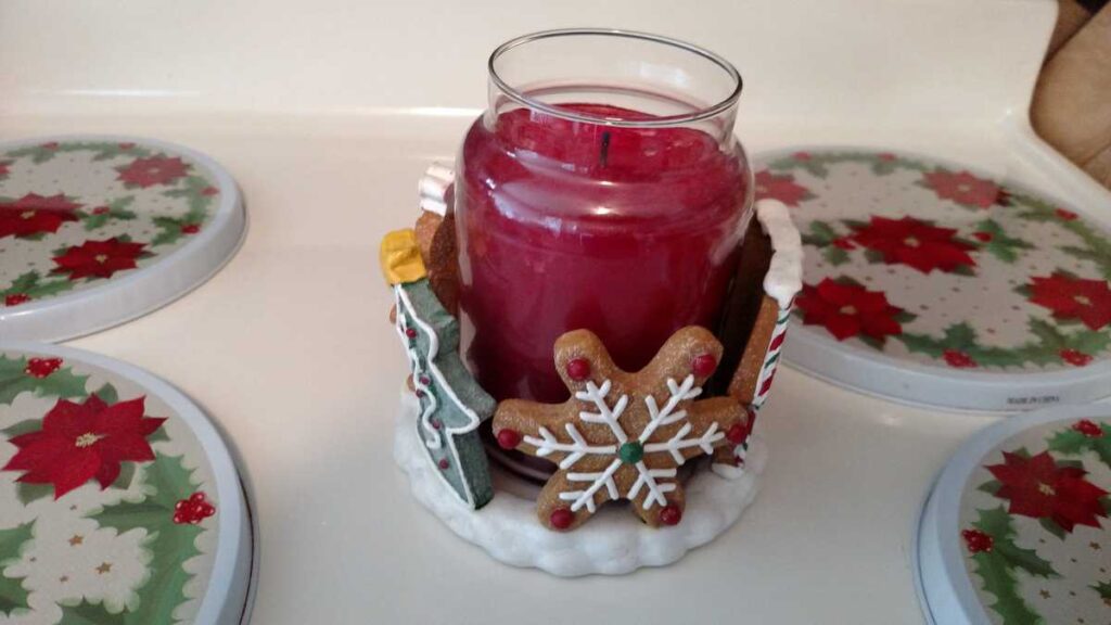 a snowflake on the gingerbread themed large candle holder