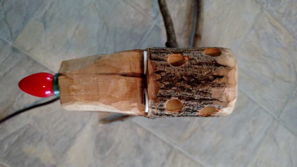 Hand Crafted Rudolph Reindeer https://www.b4andafters.com top of wooden reindeer head showing holes for ears and antlers
