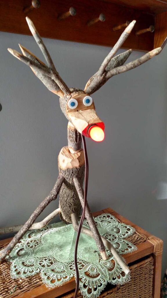 reindeer with red lightbulb nose lighted up