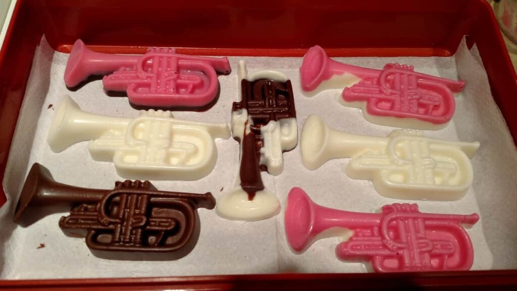 various colored chocolate trumpets with pink, white, and brown