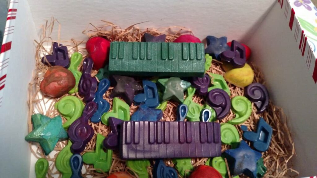 lots of various crayon shapes in music notes, a green keyboard, a purple keyboard