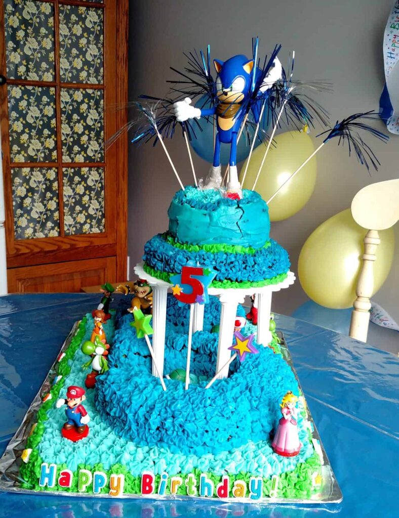 Sonic the Hedgehog 5th birthday cake with a Sonic toy on top