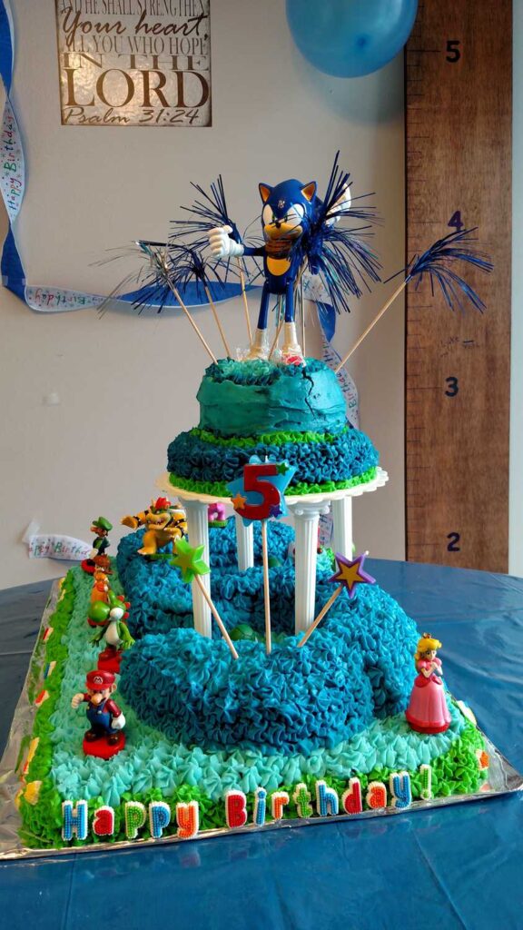 two layers of cake with Sonic the Hedgehog toy on top