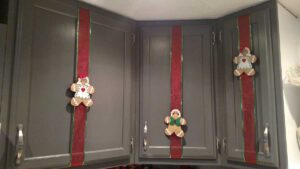 Gingerbread men on ribbons on kitchen cupboard doors