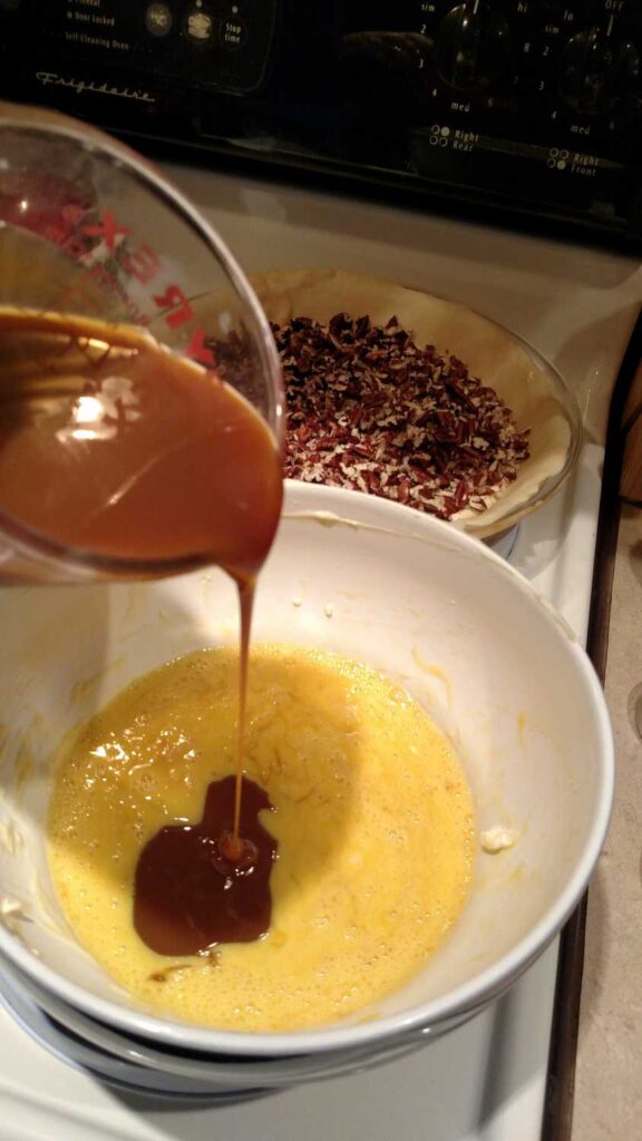 caramel being poured into egg mixture