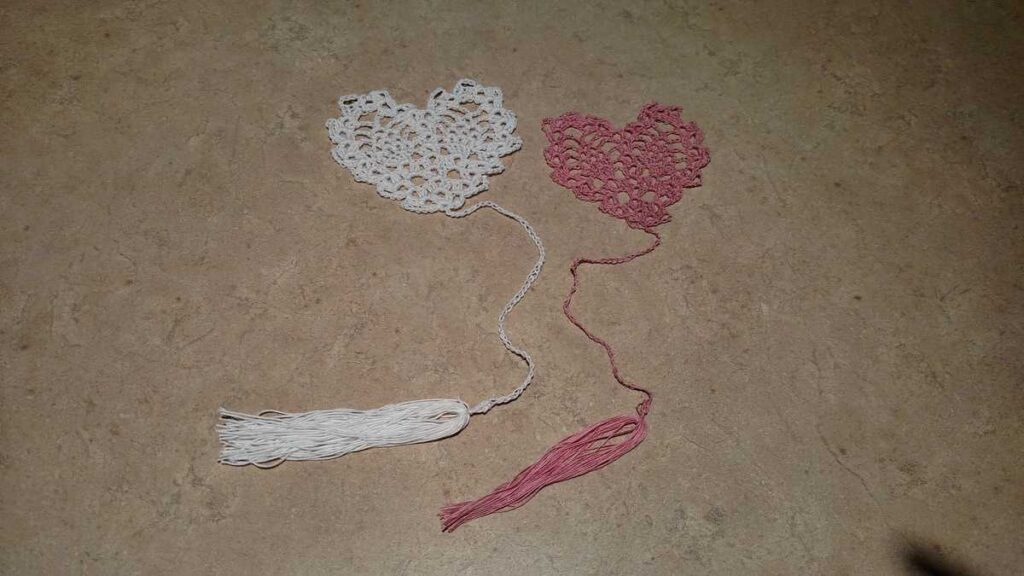 two crocheted heart shaped bookmarks