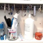 magnetic strip in medicine cabinet with lots of toothpaste tubes, contact cleanser, etc.
