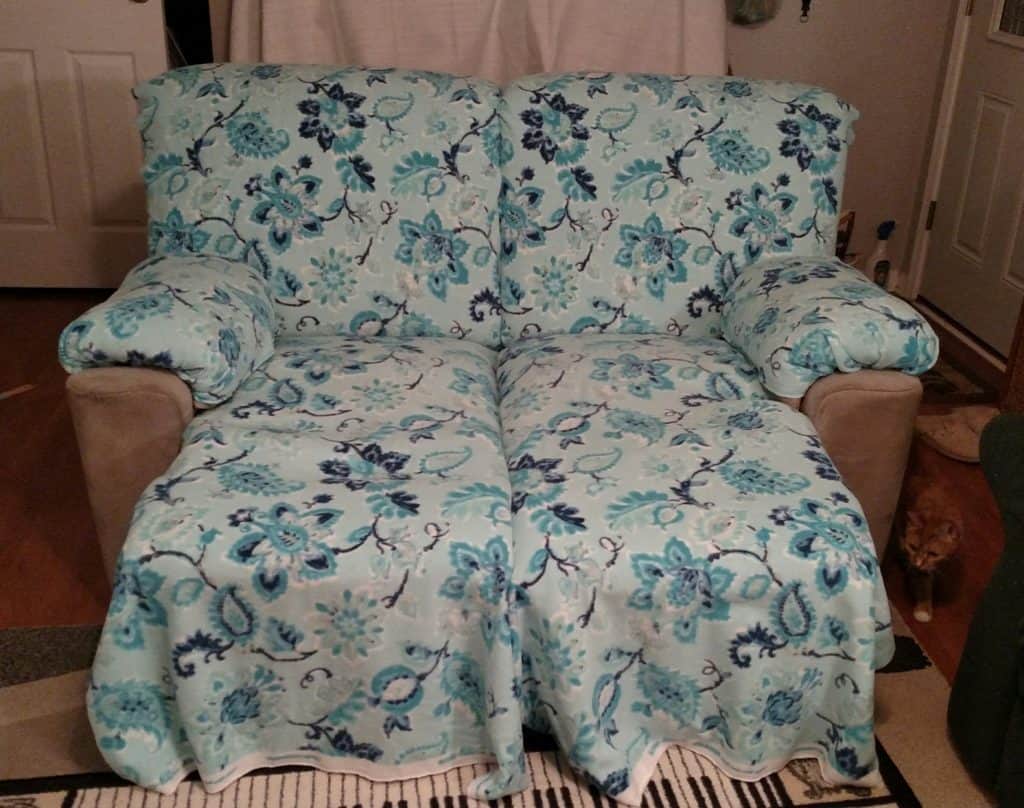 blue green floral fabric laid out and tucked nicely onto recliners