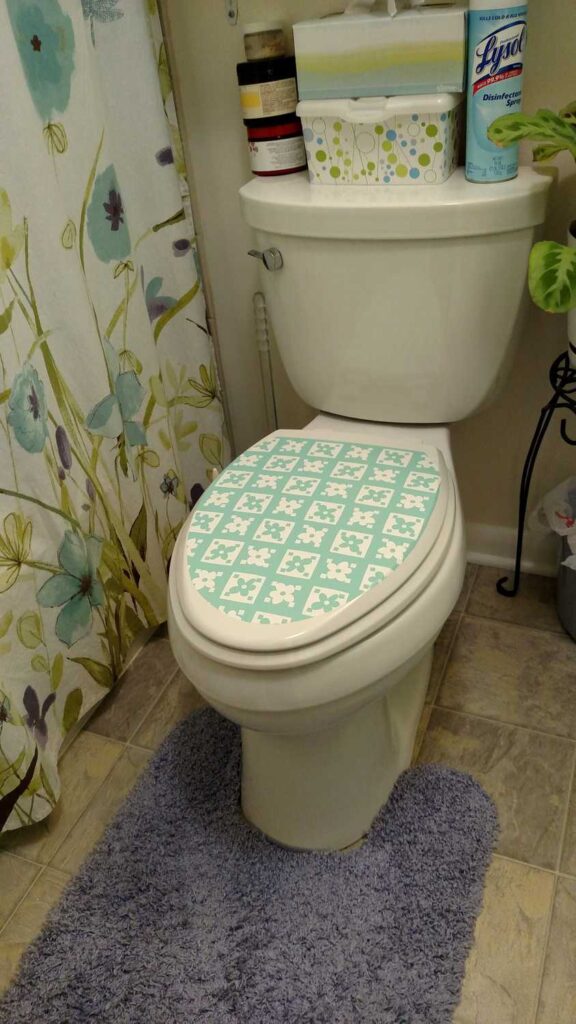 flowered contact paper on closed toilet lid