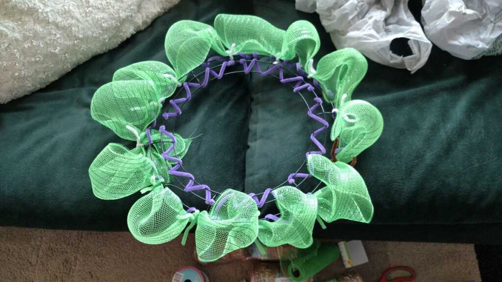 Easter Wreath Made With Dollar Tree Items twist tie mesh on a wreath frame