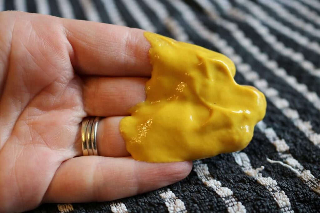 hand with mustard on it for first aid burn aid