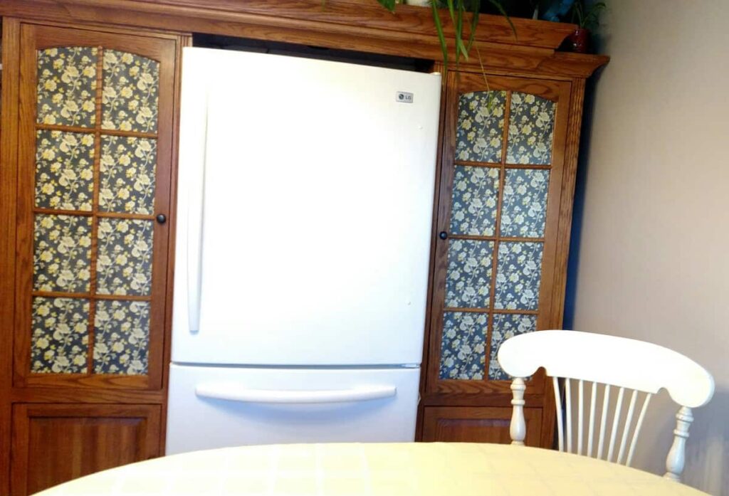 front view of the fridge with entertainment center pantries on each side