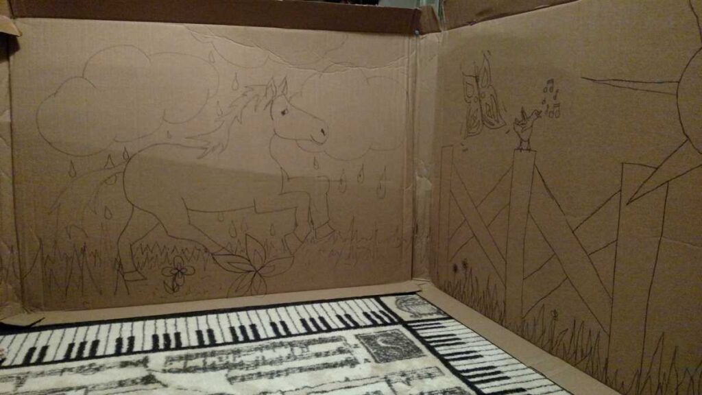 horse and fence outdoor scene drawn on a large piece of cardboard
