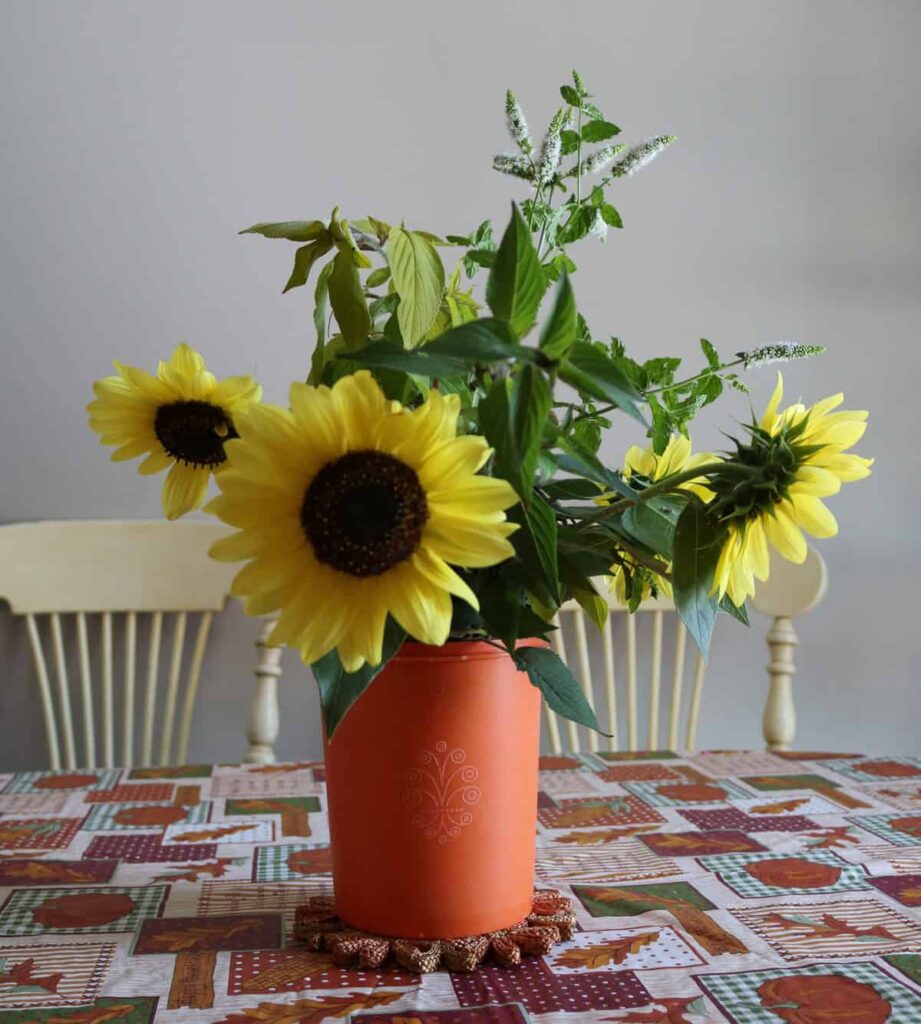 Thanksgiving Kitchen/ Fall Decor https://www.b4andafters.com sunflowers in a vintage orange Tupperware canister