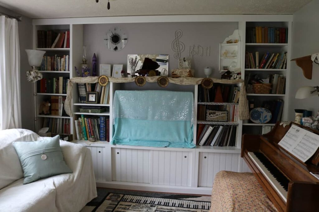 built in shelving decorated for a piano teacher