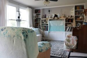 view of living space with built in shelving and windows