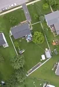 aerial view of our house and yard outlined by the white vinyl fence