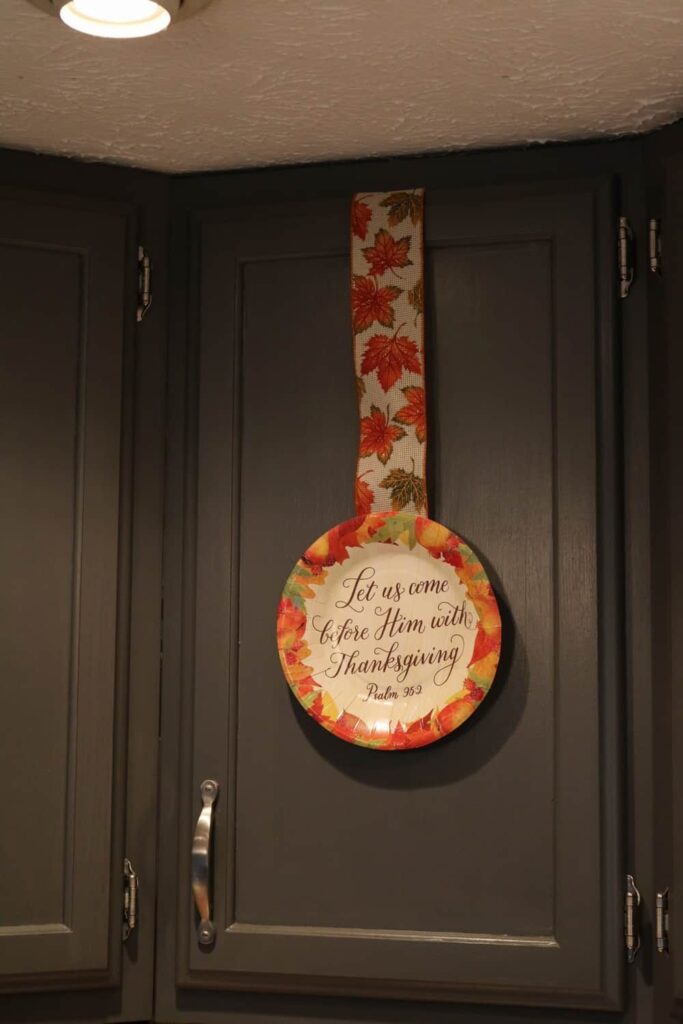 thankgiving paper plate on kitchen cabinet