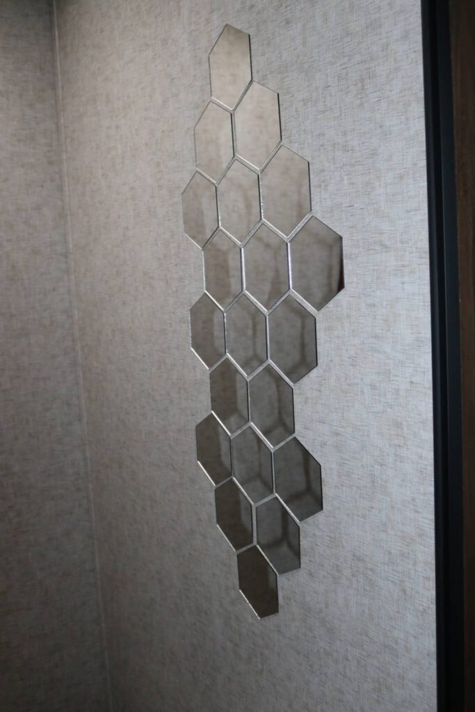 Lightweight Camper Bathroom Mirrors https://www.b4andafters.com hexagonally shaped mirrors sticking on a camper wall