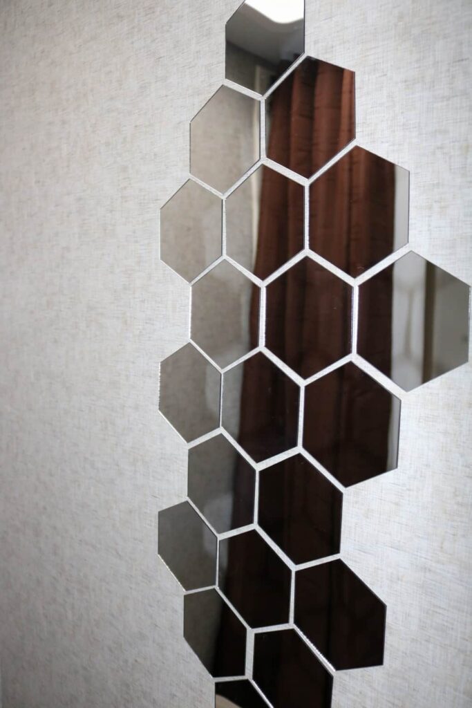 Lightweight Camper Bathroom Mirrors https://www.b4andafters.com pattern of hexagon mirrors on a wall