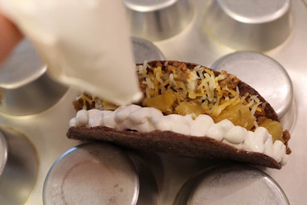 The Right Way to Fill a Taco https://www.b4andafters.com adding sour cream to taco