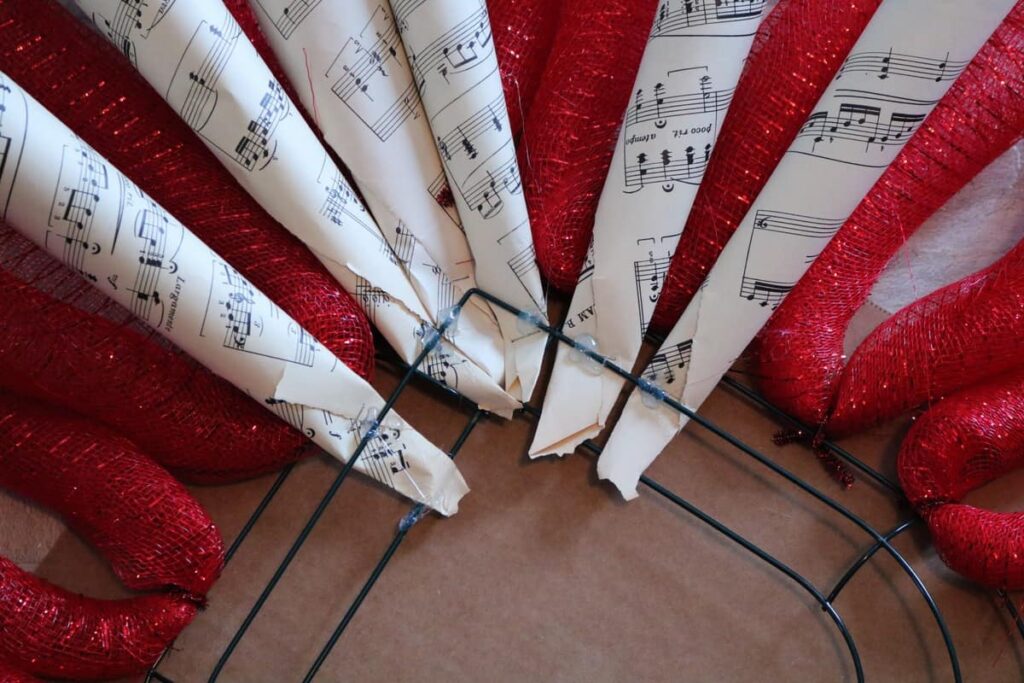 LOVE Sheet Music Wreath https://www.b4andafters.com/love-sheet-music-wreath hot gluing sheet music rolls