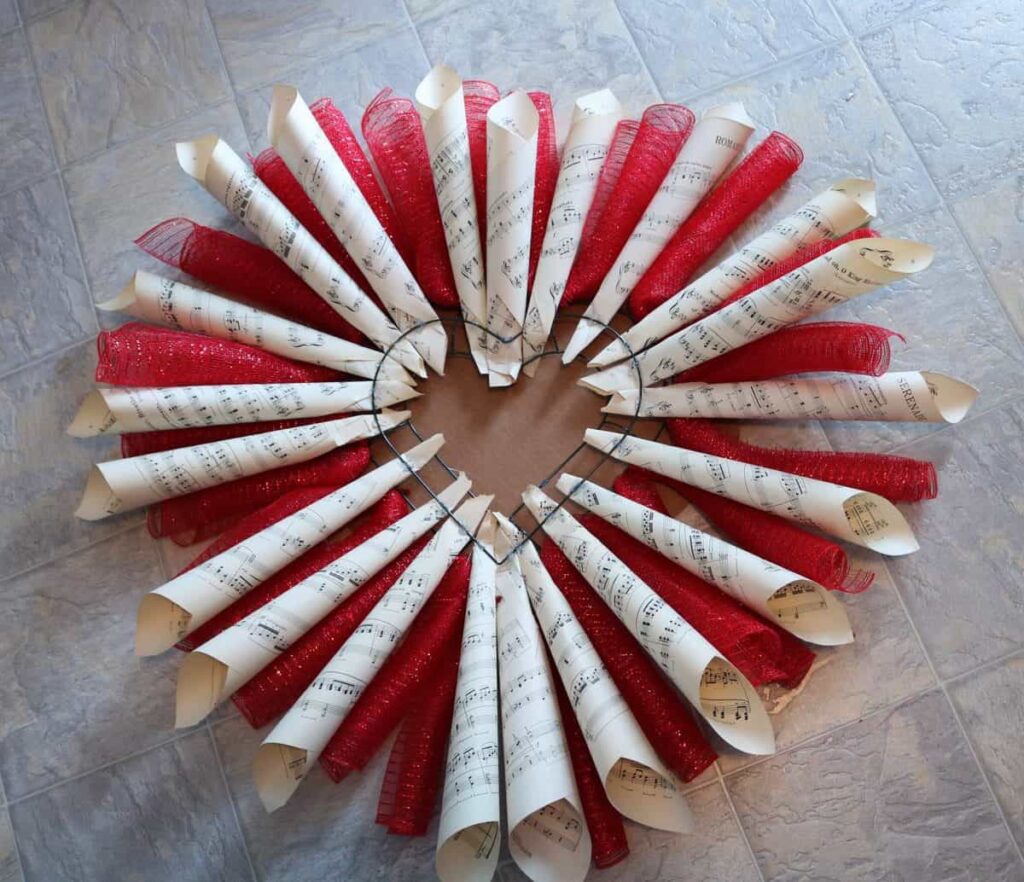 LOVE Sheet Music Wreath https://www.b4andafters.com/love-sheet-music-wreath Sheet music rolls and deco mesh hot glued to heart frame