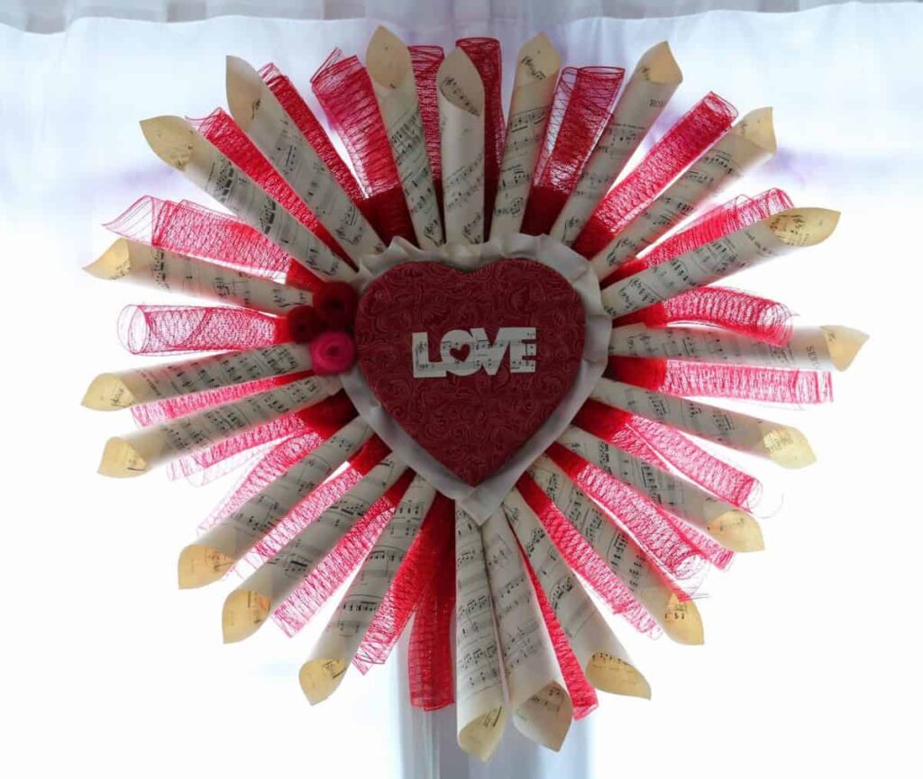 LOVE Sheet Music Wreath https://www.b4andafters.com/love-sheet-music-wreath wreath made from sheet music and red deco mesh