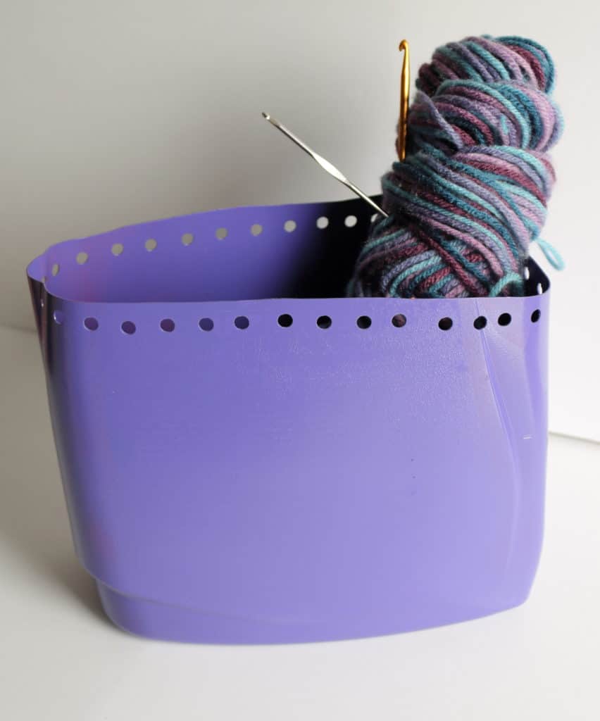 detergent container with yarn and crochet hooks