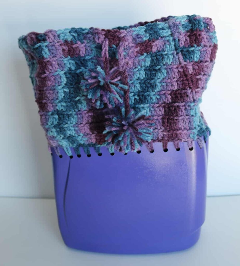 laundry detergent container with yarn crocheted onto it