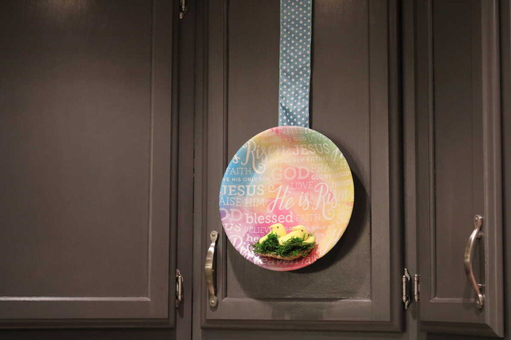 Easy Easter Kitchen Cabinet Decor https://www.b4andafters.com cabinet decorated with paper plate and marshmallow peeps nest