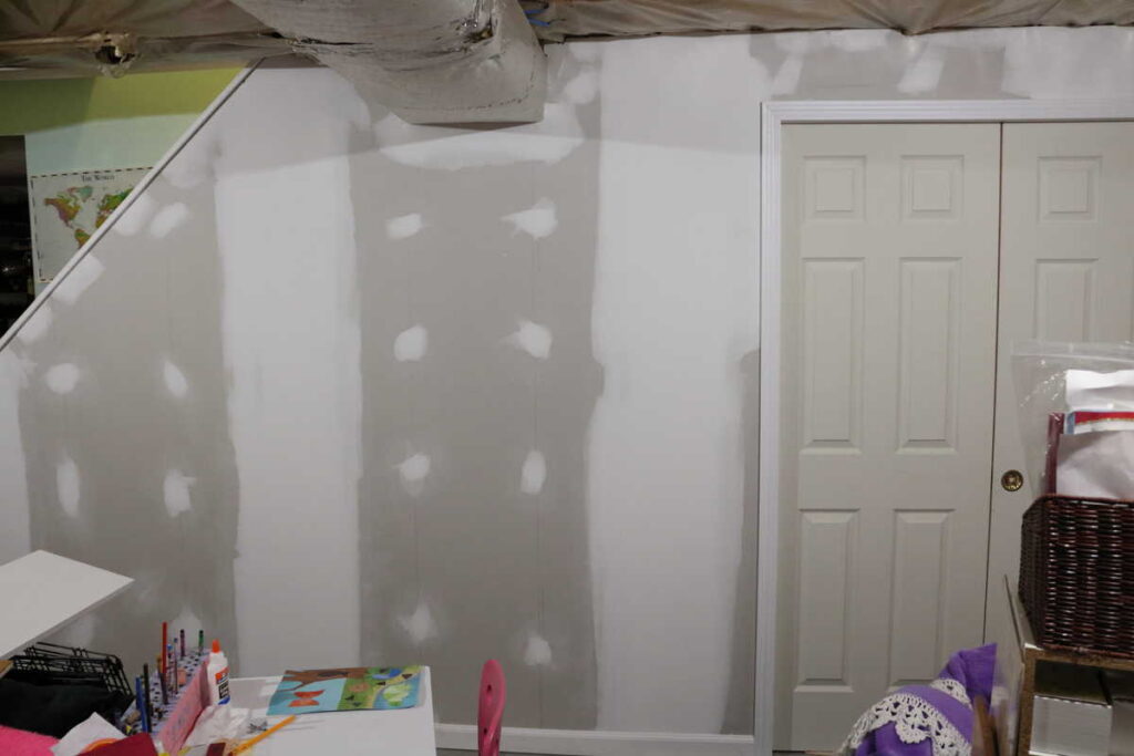 Pocket Doors in Basement Wall https://www.b4andafters.com mudding basement wall