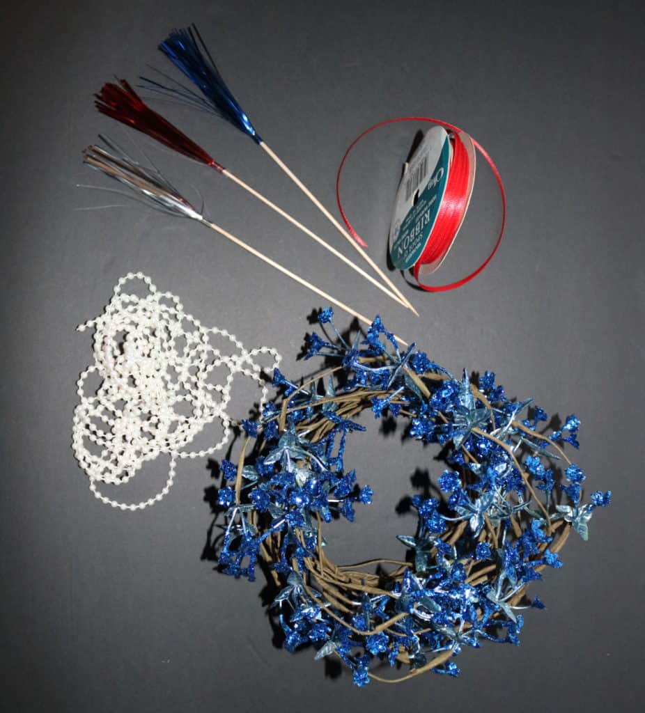 3 fireworks toppers, red ribbon, pearl string of beads, blue flowers