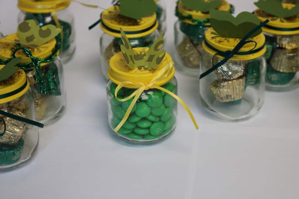 baby food jars with painted lids and candy in them