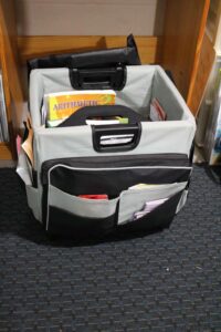 rolling storage tote with black and gray pockets