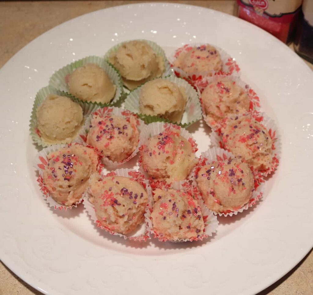 edible sugar cookie dough recipe on mini paper liners, some with sugar sprinkles and some plain