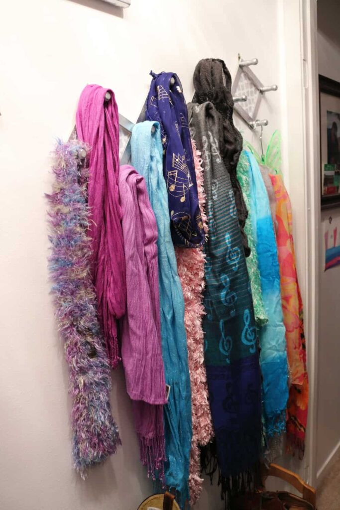 scarves on accordion peg hooks