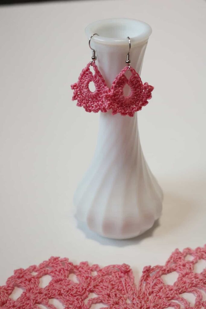 pink earrings hanging from a vase https://www.b4andafters.com/easy-crocheted-earrings/