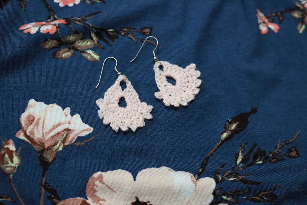 peach earrings on a floral background https://www.b4andafters.com/easy-crocheted-earrings/