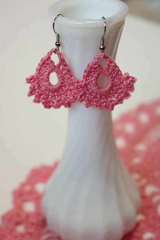 pink earrings hanging from a vase https://www.b4andafters.com/easy-crocheted-earrings/