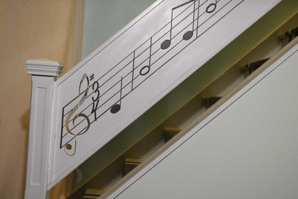 a closeup of the new music railing https://www.b4andafters.com/music-stair-railing