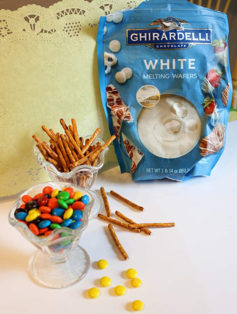 ingredients: white chocolate melting wafers, pretzel sticks, and M+Ms