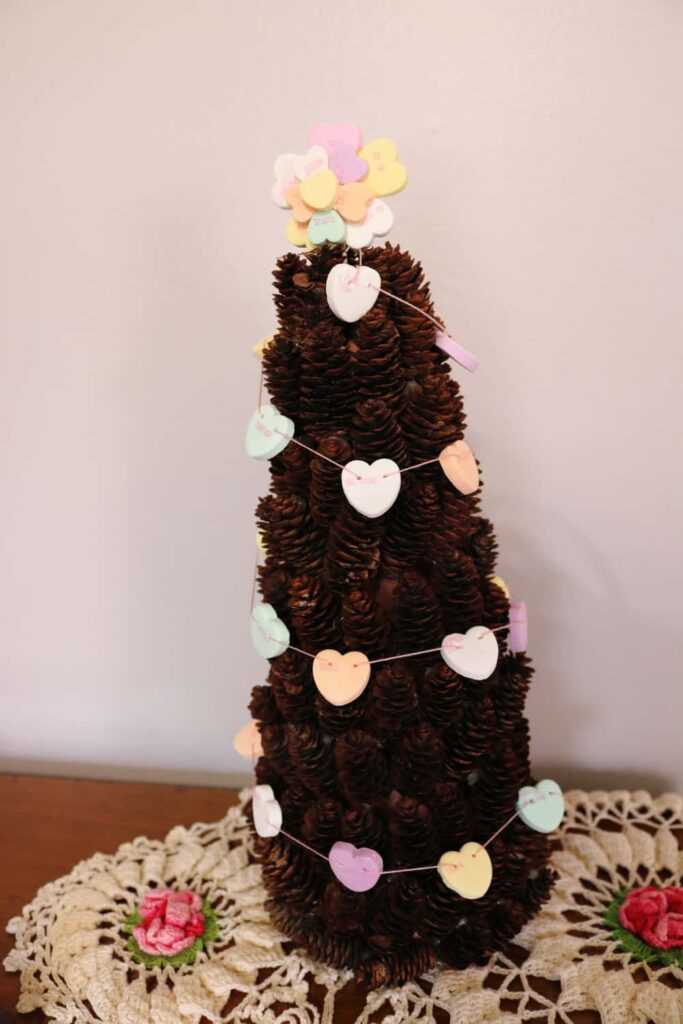 Miniature pine cone tree with conversation heart garland and topper https://www.b4andafters.com/conversation-heart-garland