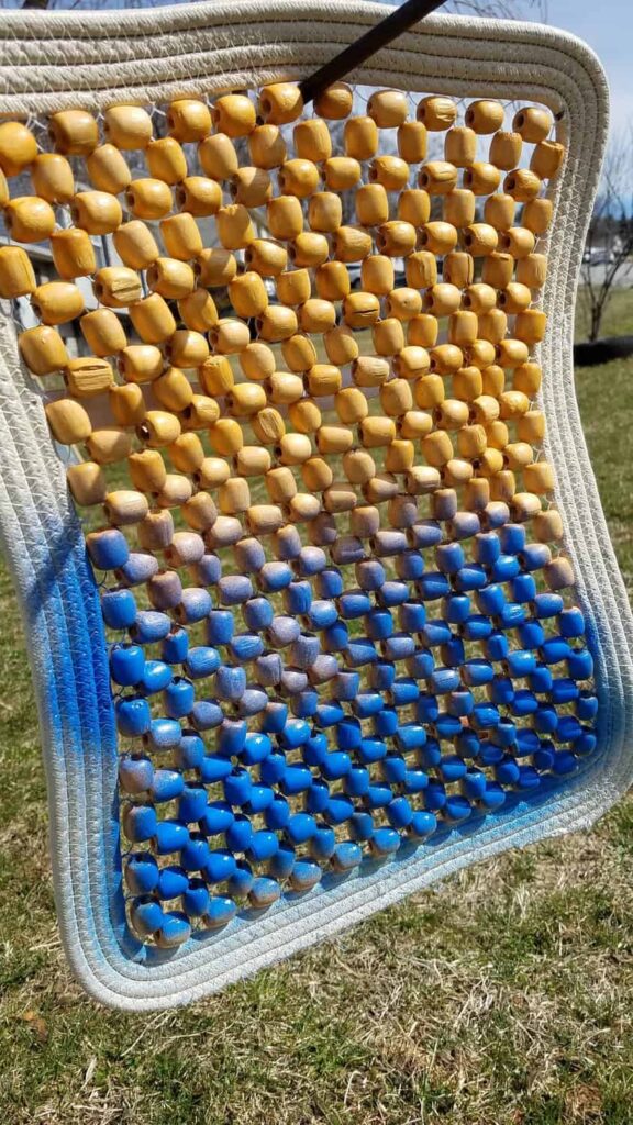 some wooden beads partially sprayed with blue paint
