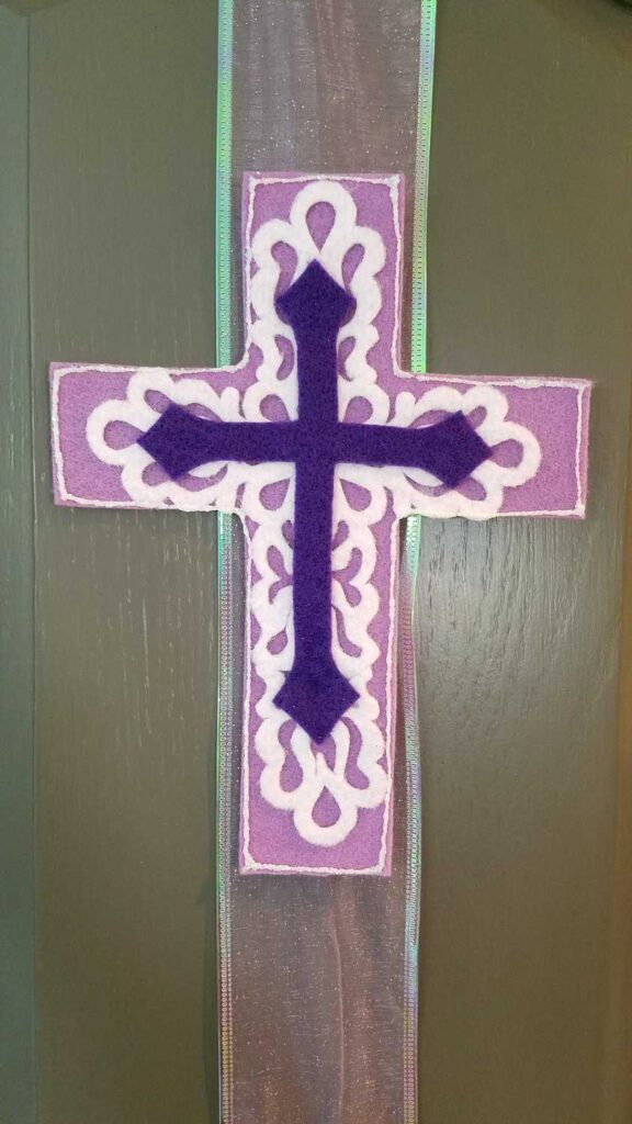 felt cross attached to ribbon