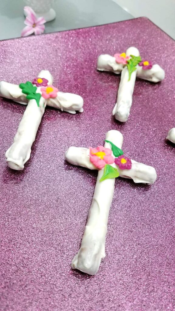 homemade chocolate covered pretzel cross with flowers and leaves