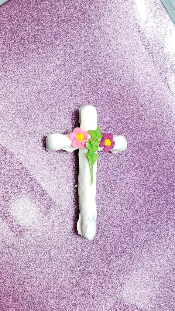 gorgeous white chocolate covered cross pretzel with leaves and flowers